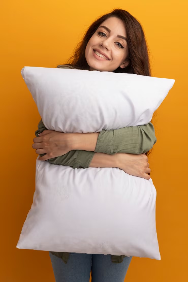 Smiling Young Beautiful Girl Wearing Olive Green T Shirt Hugged Pillow by Orient Uniforms for customers in Dubai, Abu Dhabi, Sharjah, Ajman and across the UAE